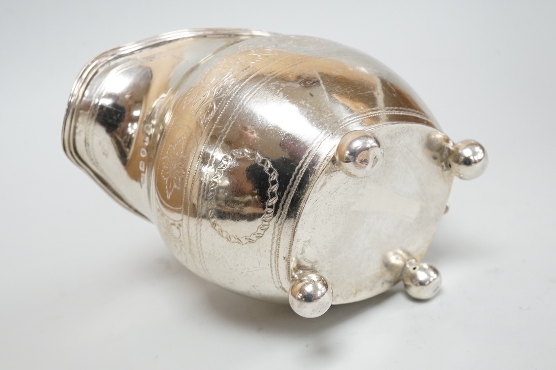 A George III silver cream jug, on four ball feet, London, 1812, 95mm, with engraved foliate band, maker's mark rubbed.